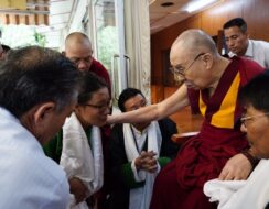 A crowd of people greeting the Dalai Lama of Tibet.