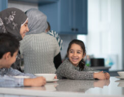 Woman and children in the kitchen happy