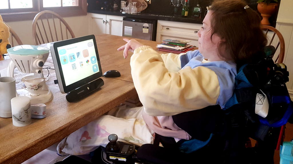 Taylor at home using her eye-gaze device.