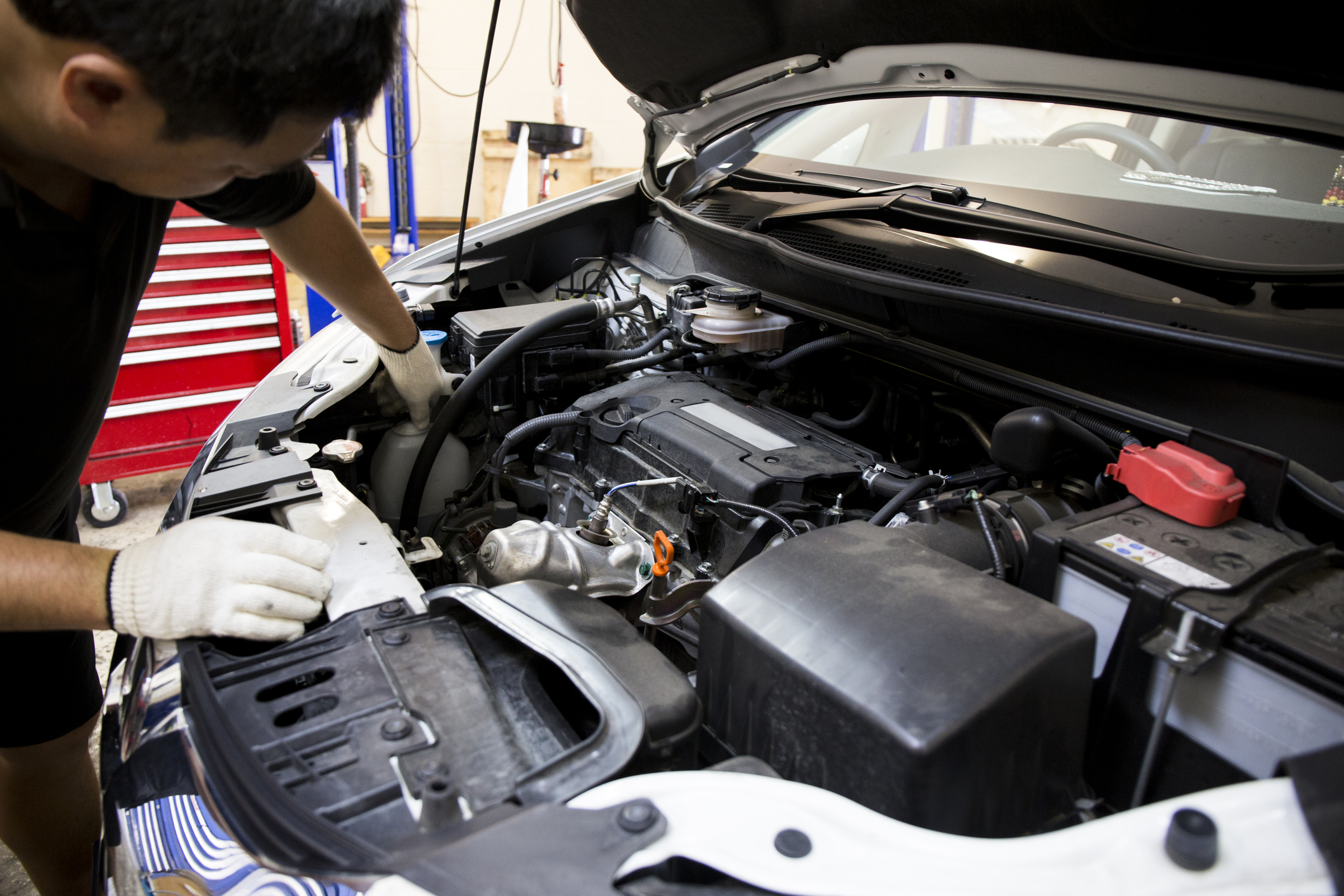 SSI LAC participant, Charlie, working on a car in garage