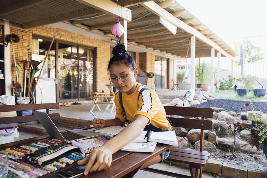 Woman looking at colour charts on a desk outside