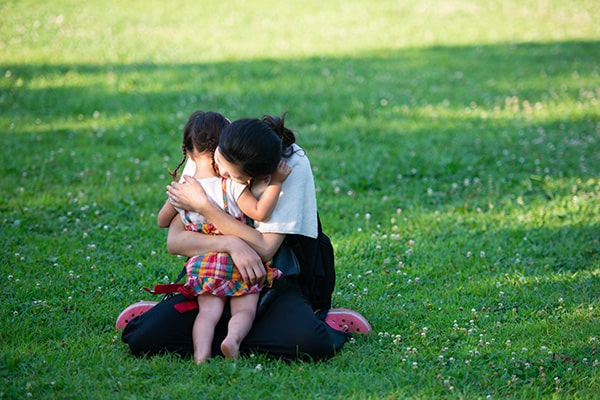 Woman hugging small child in a park