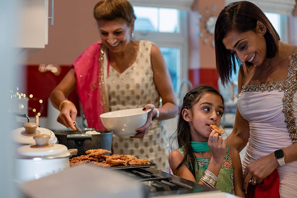 Women cooking with children in the kitchen