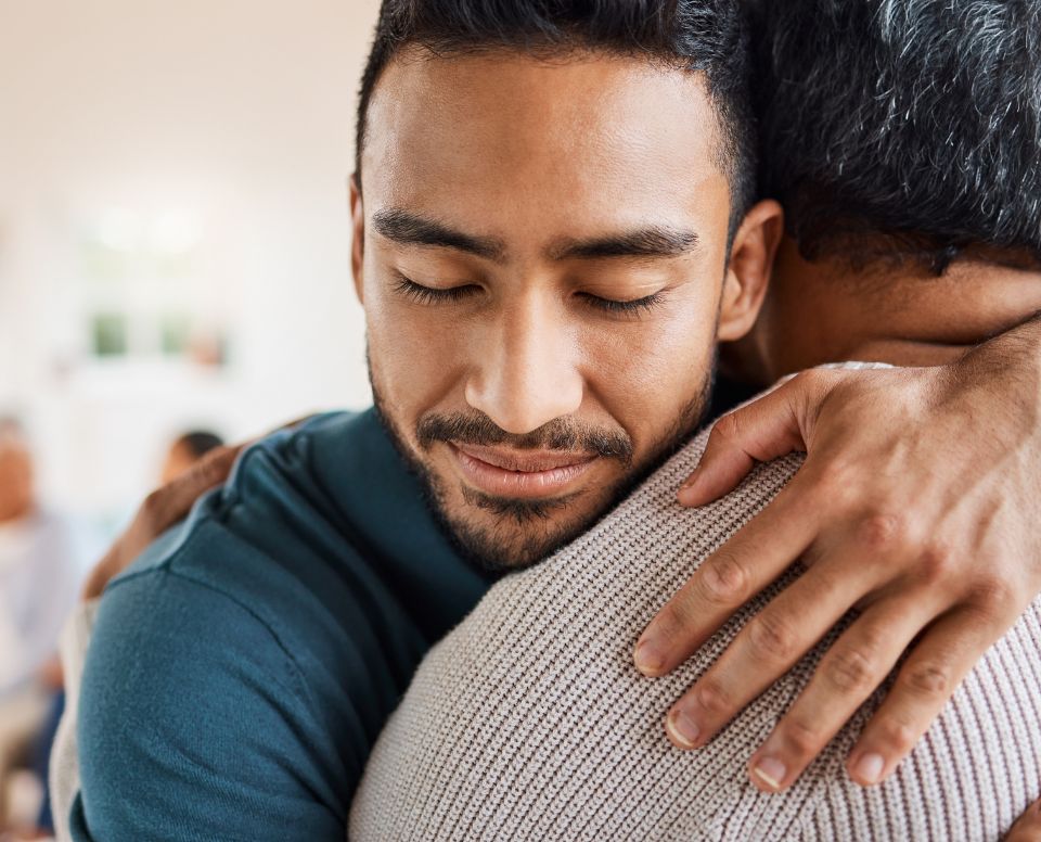 Two men hugging