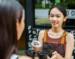 Woman serving coffee to a customer