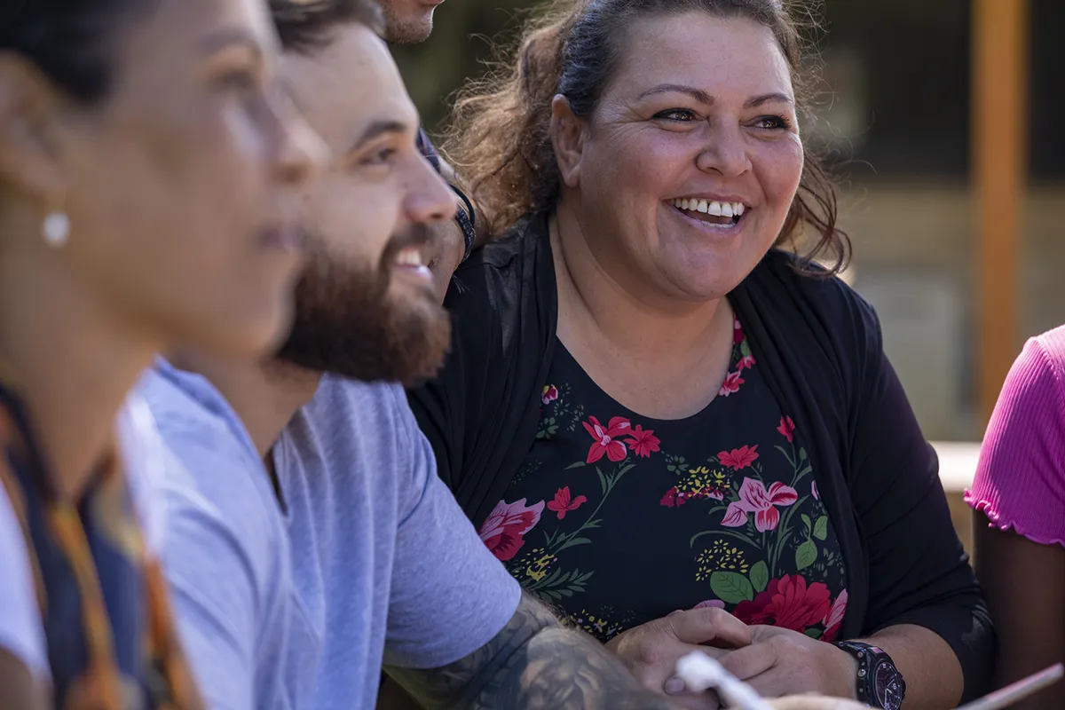 Woman smiling with a group outdoors